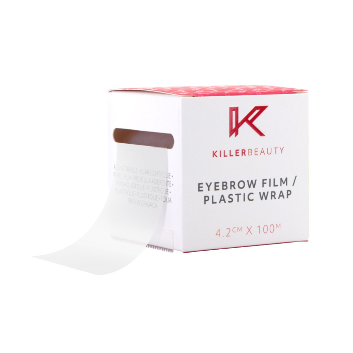 Une boîte blanche et rouge étiquetée Film pour Sourcils Killer Beauty / Pellicule Plastique (4.2 CM x 100 M) avec un rouleau de film transparent partiellement distribué par une fente latérale.